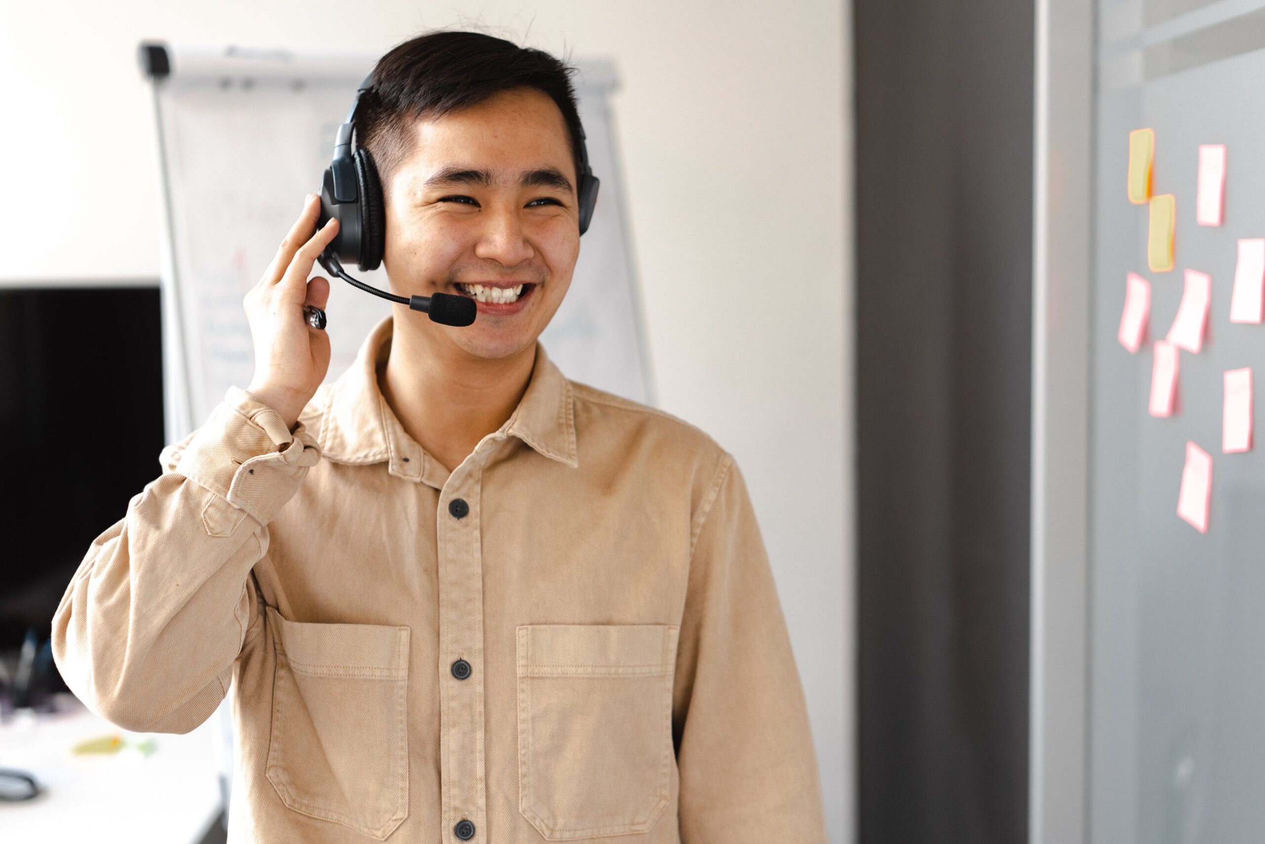 a man in a khaki shirt and headphones
